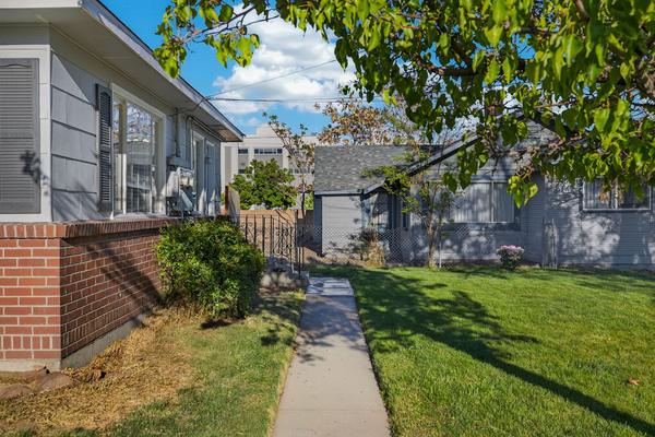 Path along the side of the house between the red brick base and the lawn